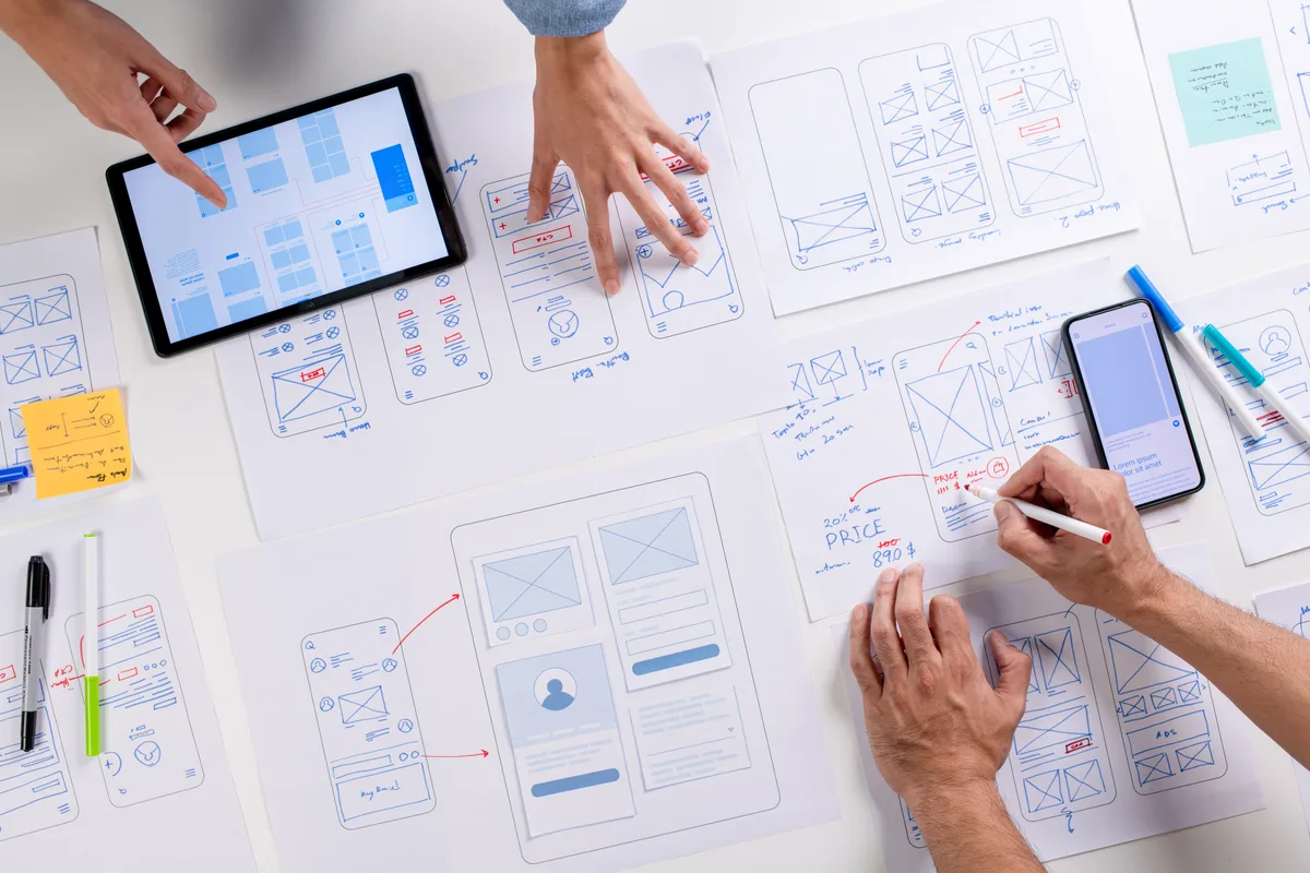 UX designers sketching website wireframes during a redesign planning session