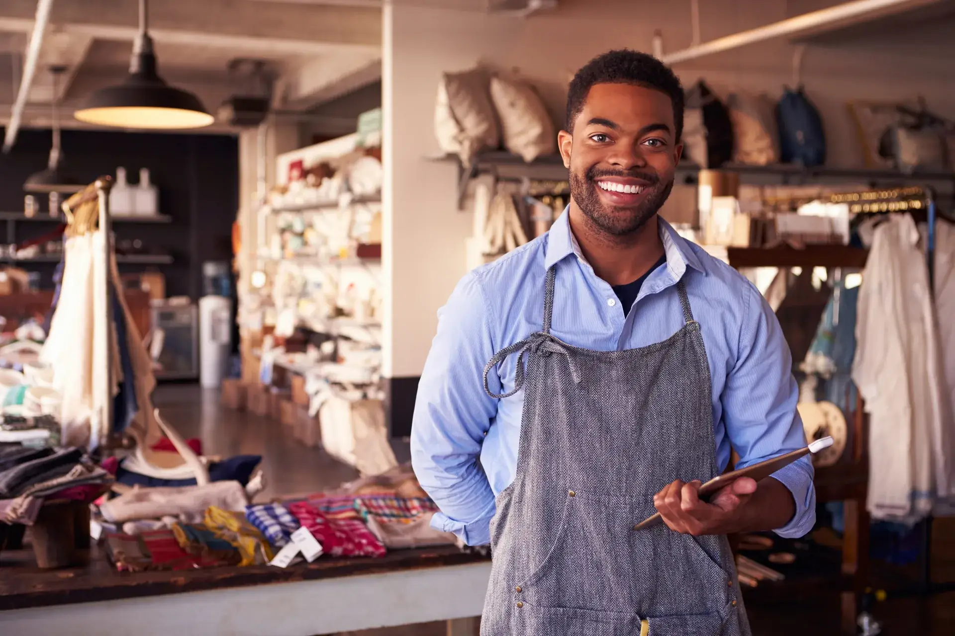 A small-business owner in his shop checking results on a tablet — the person the guarantee exists for