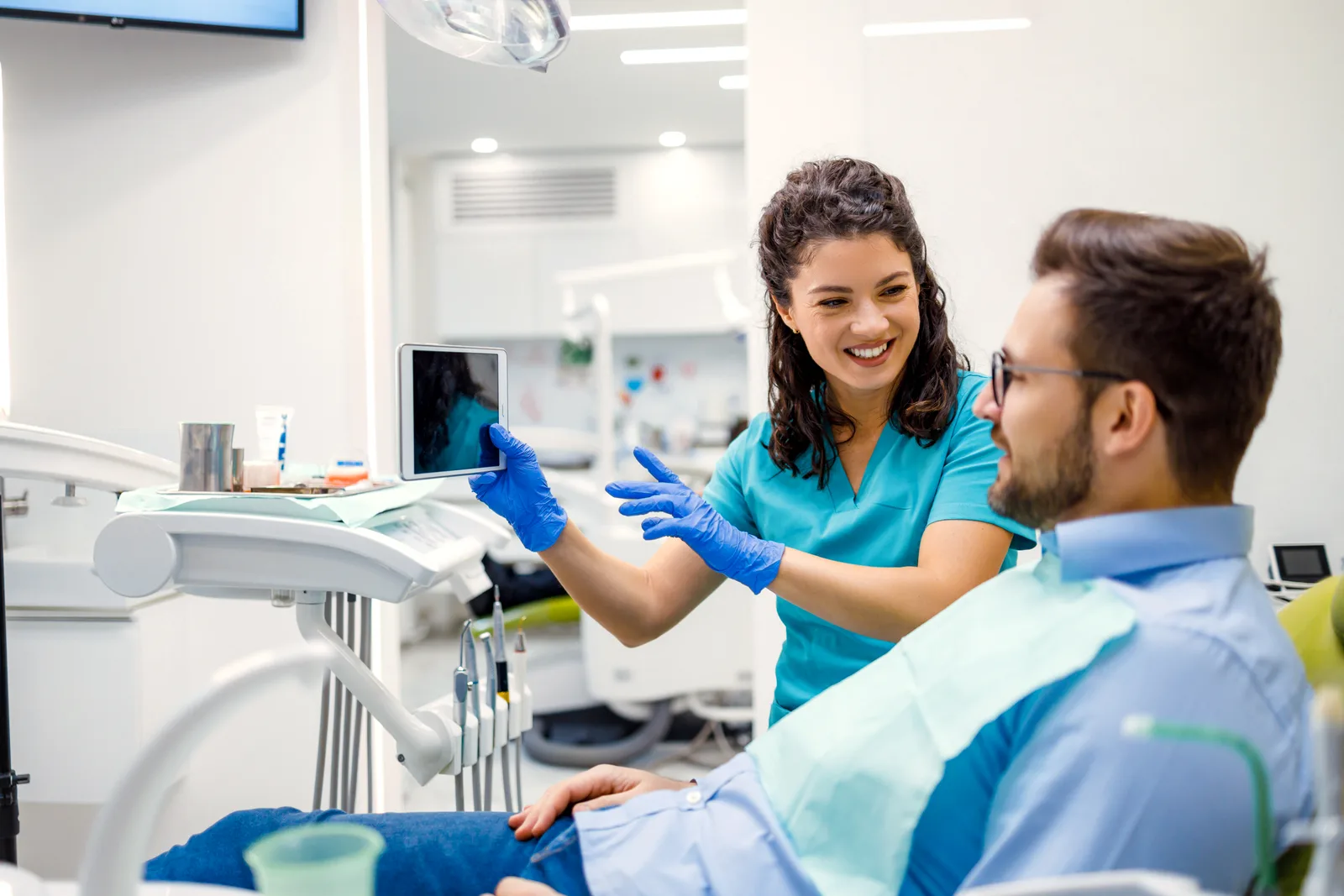 Dentist walking a new patient through a treatment plan chairside in a modern practice
