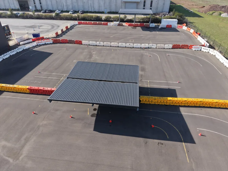 Aerial view of a closed practice driving course marked out with cones and safety barriers