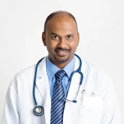 Dr. Sanjay Mehta, a pediatrician in a white coat with a blue stethoscope, smiling warmly