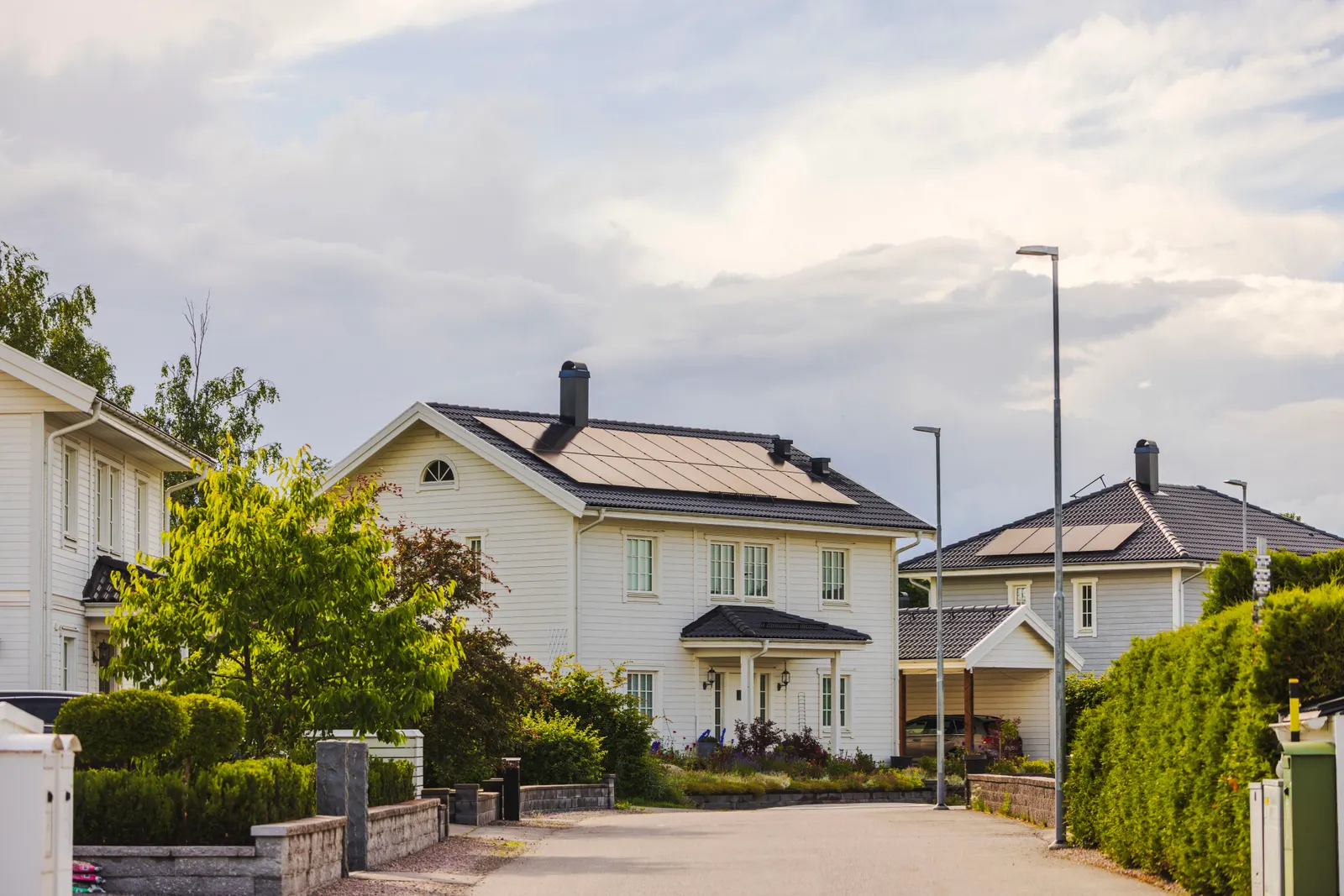 Two-story home with a full rooftop solar array under a soft evening sky