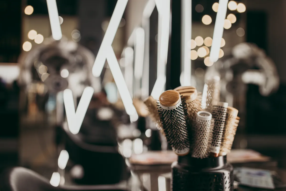 Elegant beauty salon interior with professional styling stations and soft lighting