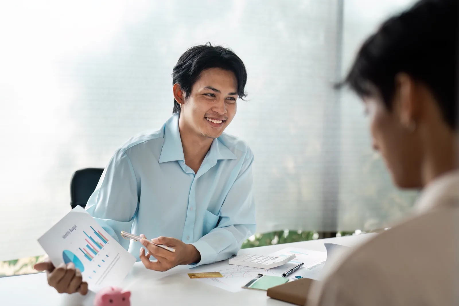 Debt relief counselor walking a couple through their payoff options at an office desk