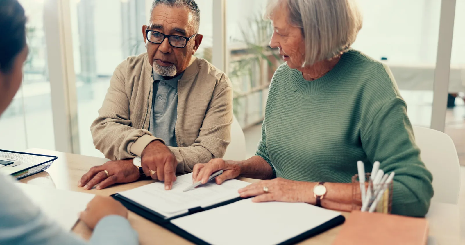 Disability attorney walking a claimant through SSDI appeal paperwork at her office desk