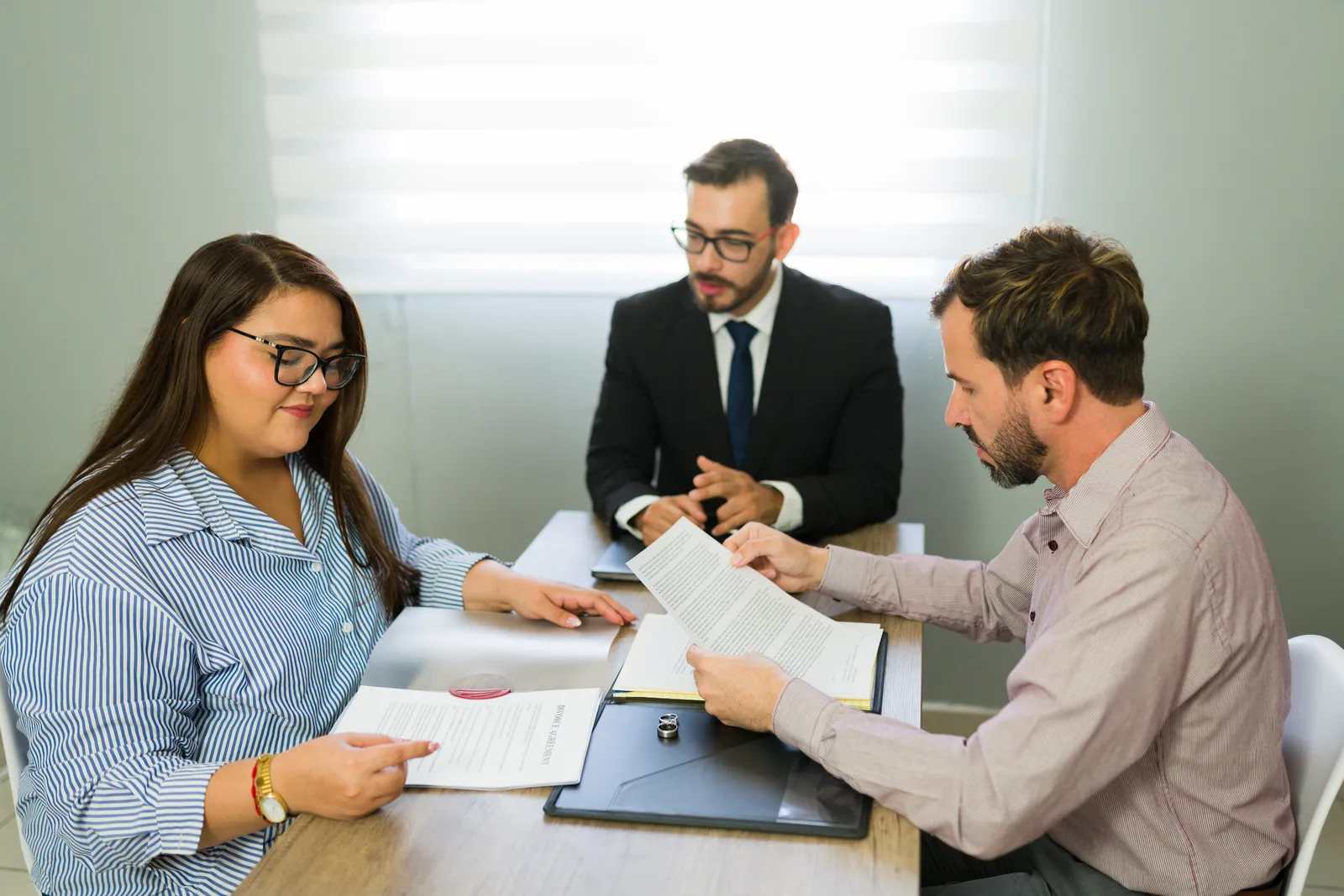 Family law attorney at her desk walking a client through the terms of a divorce agreement