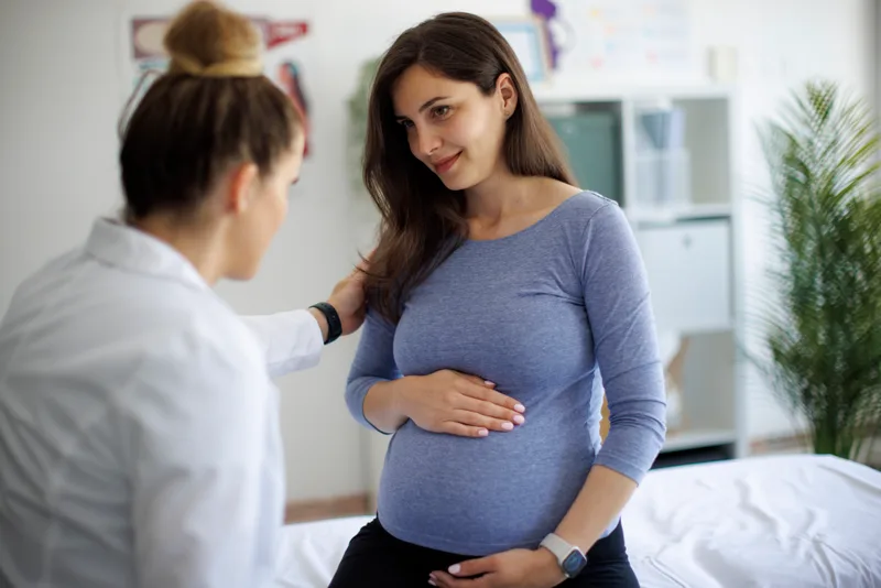 OB/GYN doctor consulting with a pregnant patient