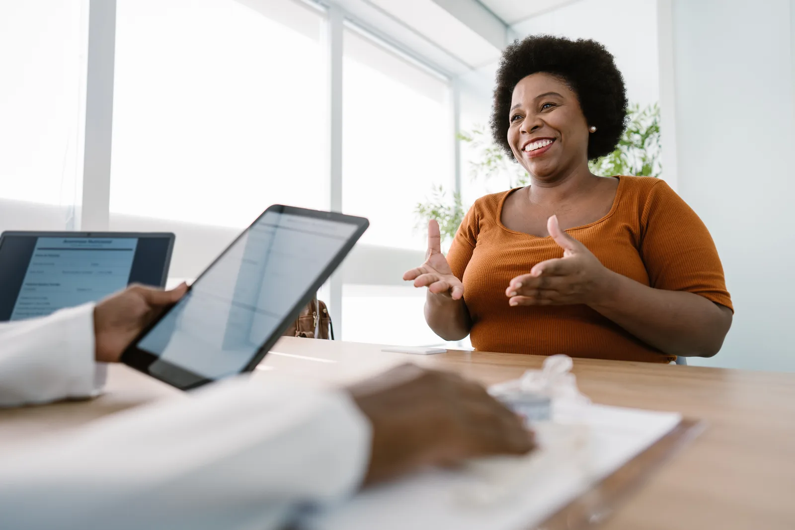 Physician reviewing a medical weight-loss plan with a patient in a clinic consultation room