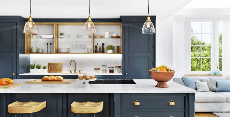 Renovated navy-blue kitchen at 156 Schneider Avenue with a marble island, brass stools and pendant lighting