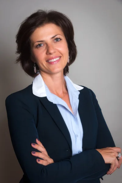 Dana Whitfield, director of owner accounting, smiling with arms crossed in a dark blazer