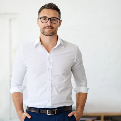 Portrait of Marcus Ehrlich, managing partner at Northloop Collective, in a white shirt and glasses